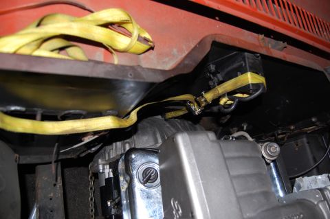 1994 Ford Bronco - Yellow straps are used to secure engine components in this view of an engine bay.