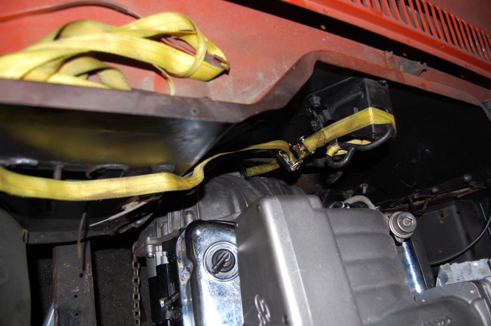 Engine bay with yellow straps securing components