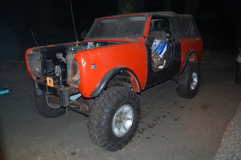 1994 Ford Bronco - An orange International Harvester Scout II is shown with its front end disassembled and large off-road tires.
