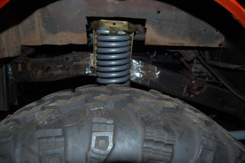 1994 Ford Bronco - Close-up view of the front suspension spring and tire on a 1994 Ford Bronco.