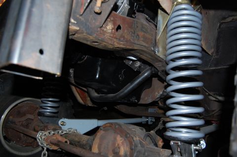 1994 Ford Bronco - The undercarriage of a vehicle is shown, focusing on the suspension components and frame structure.
