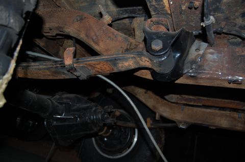1994 Ford Bronco - Close-up of vehicle undercarriage, focusing on suspension and drivetrain parts.