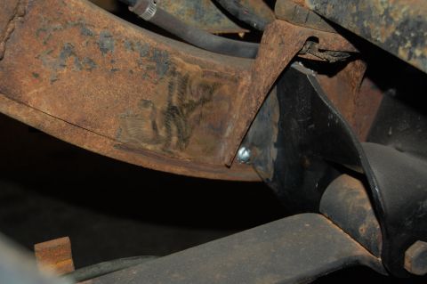 1994 Ford Bronco - Detail of rusted vehicle undercarriage components, showing frame and suspension elements.