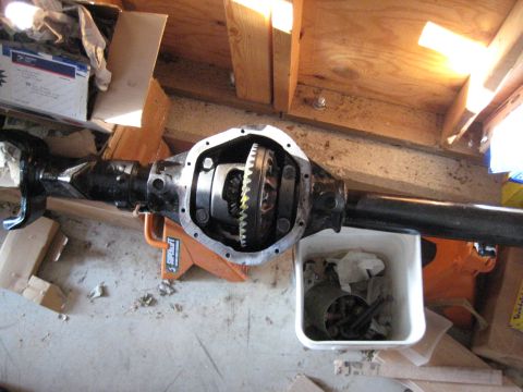 1995 Ford Bronco - A differential axle assembly is shown on an orange jack stand, with its housing open to reveal the internal gears.