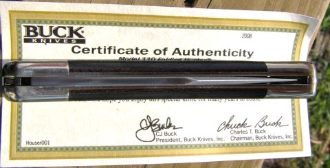2000 Ford Crown Victoria - A Buck 110 folding knife is displayed on its certificate of authenticity, dated 2008.