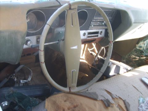 1971 Pontiac Lemans - The interior of a 1971 Pontiac Lemans shows a cracked dashboard and a worn steering wheel.