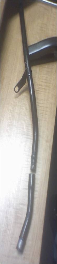1996 Ford Bronco - A damaged metal pipe with a bracket is shown on a wooden surface.