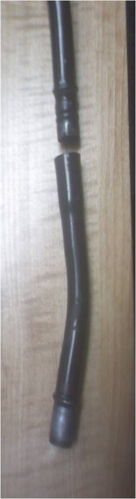 1996 Ford Bronco - A black rubber hose, broken into two sections, lies on a wooden surface. Text at the bottom reads 'SUPERMOTORS www.supermotors.net'.