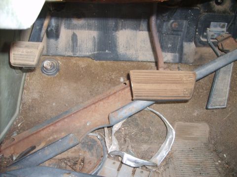 1971 Pontiac Lemans - Interior view of a car's floor, showing pedals and rusty trim.