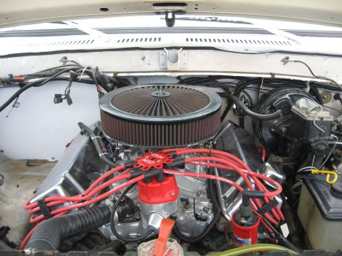 1979 Ford Bronco - V8 engine with aftermarket air filter and ignition system components.