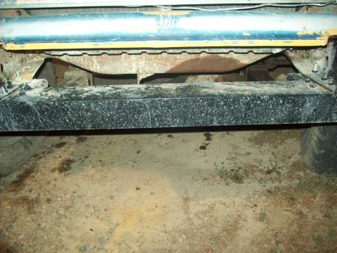 1971 Ford F-100 - The rear frame and bumper assembly of a truck is shown, with visible suspension parts and tires on either side.