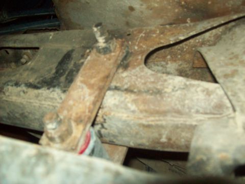 1971 Ford F-100 - Underside view of heavily rusted truck frame and suspension parts.