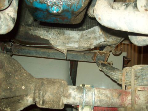 1971 Ford F-100 - Close-up of the undercarriage, showing the rear axle, leaf springs, and part of the engine block.