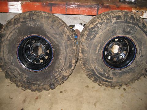 1986 Ford Bronco - Pair of large off-road tires and wheels, likely for a truck or SUV, shown up close.