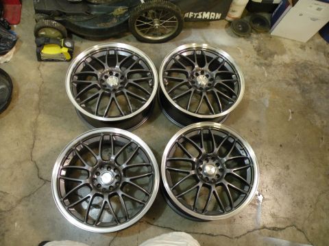 1998 Subaru Legacy - Set of four aftermarket wheels, each a multi-spoke design and a polished lip.