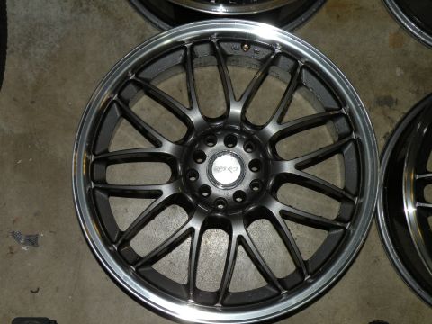 1998 Subaru Legacy - A single aftermarket wheel is shown, with other wheels visible in the background.