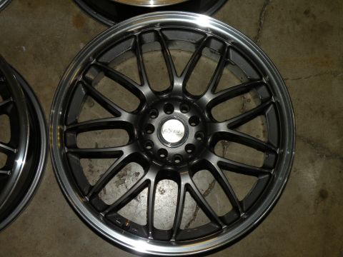 1998 Subaru Legacy - A single aftermarket wheel is shown, with a dark gray finish and a polished lip.
