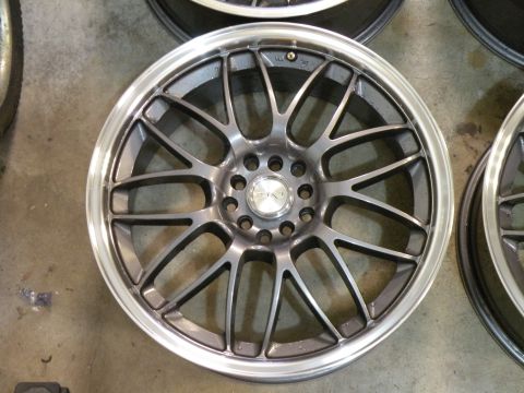 1998 Subaru Legacy - A single alloy car wheel is shown, with multiple spokes and a polished rim.