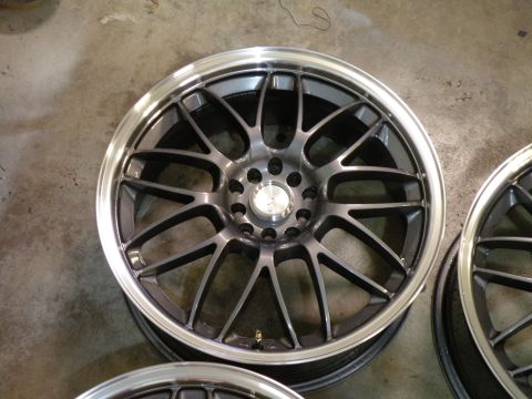 1998 Subaru Legacy - A close-up view of a set of aftermarket alloy wheels, showing their intricate spoke design and polished rim.