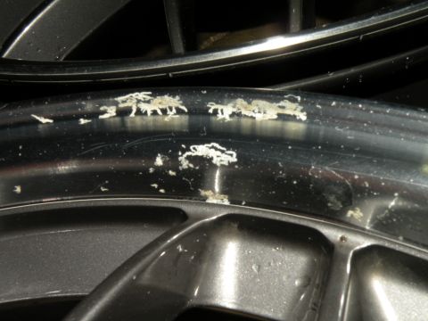 1998 Subaru Legacy - Debris is stuck to the rim of a car wheel.