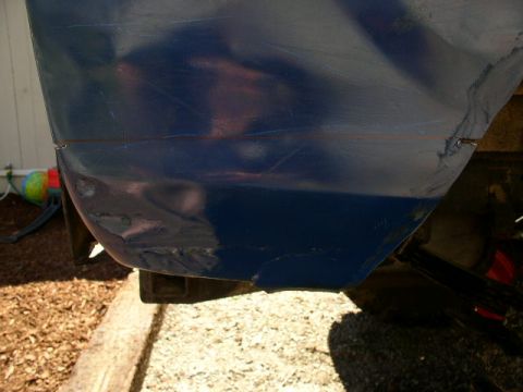 1979 Ford Bronco - Detail of a blue boat hull showing wear and tear on the exterior surface.