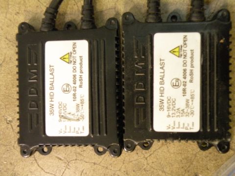 1998 Subaru Legacy - Two black HID ballasts are shown side-by-side, each with a white label detailing specifications.
