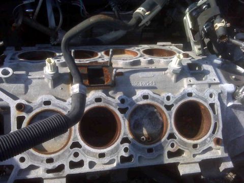1995 Ford Bronco - This is a close-up view of an engine block, showing the cylinder bores and some attached hoses.