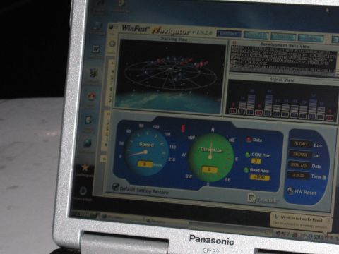 2001 Ford Crown Victoria - A laptop displays GPS tracking software with various data readouts and graphical interfaces.