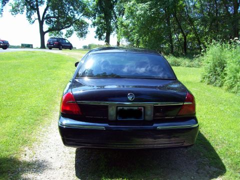 1999 Mercury Grand Marquis - Rear view of a 1999 Mercury Grand Marquis parked outdoors on a gravel driveway.