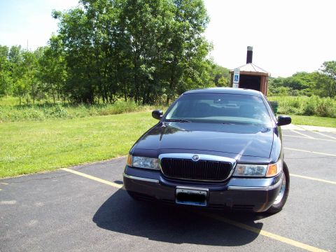 1999 Mercury Grand Marquis - This dark sedan's grille and body style suggest a 2003 model year, not a 1999 Mercury Grand Marquis.