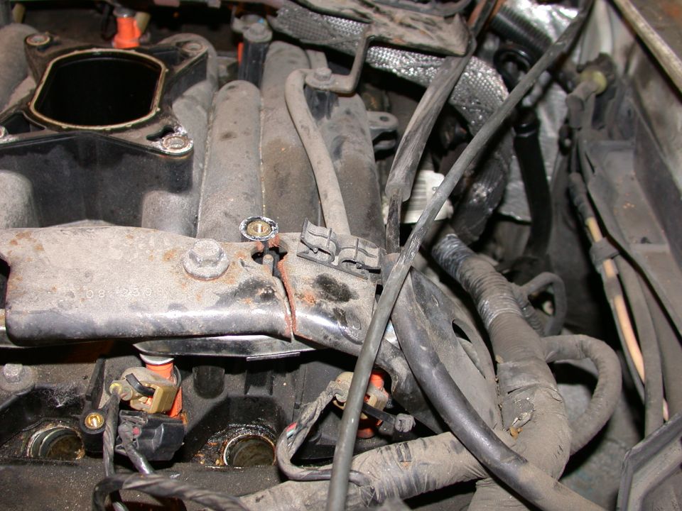 Engine intake manifold with visible wiring and hoses