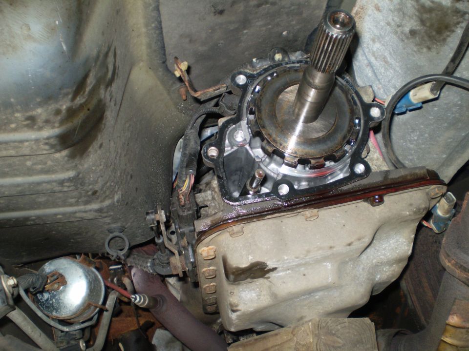 Close-up of a vehicle's transmission output shaft and housing