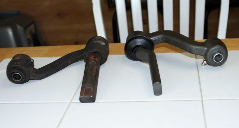1976 Ford Ranchero - A comparison of a worn suspension control arm next to a new replacement part.