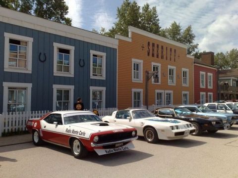 1991 Ford LTD Crown Victoria - Several classic cars are parked in front of buildings designed to look like an old Western town.