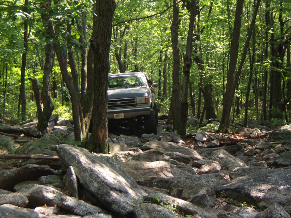 Gray 1987 Ford F-150 off-roading on a rocky trail