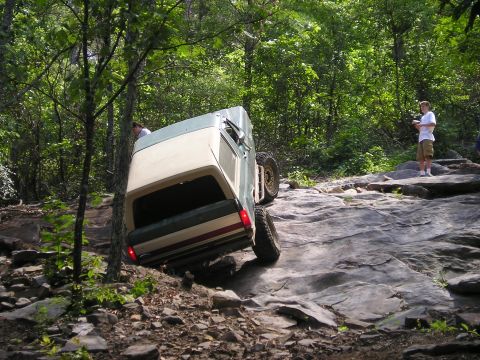 1989 Ford Bronco - This 1989 Ford Bronco is navigating a challenging rocky terrain during an off-road excursion.
