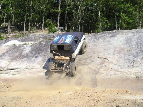 1989 Ford Bronco - This 1989 Ford Bronco is tackling a challenging off-road trail on a sunny day.