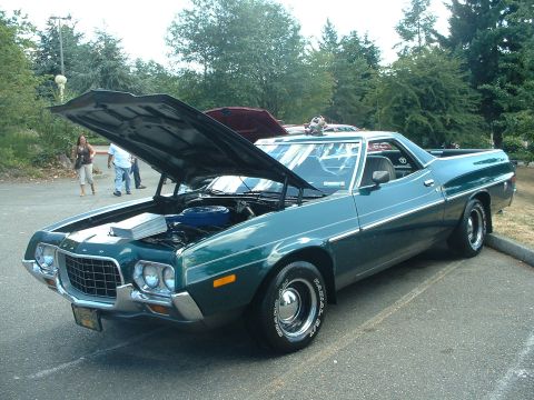 1999 Ford Crown Victoria - A green 1972 Ford Ranchero is displayed with its hood open at an outdoor car event.