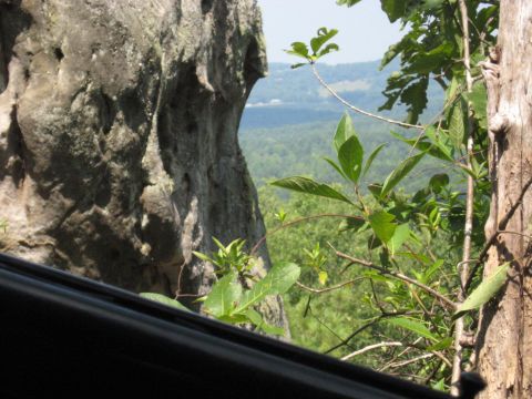 1978 Ford Bronco - Scenic overlook with rock formations and lush greenery, viewed from inside a vehicle.