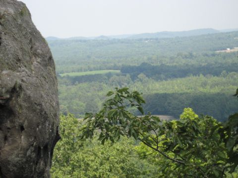 1978 Ford Bronco - View from a rocky outcrop across a vast expanse of green forest and distant hills.