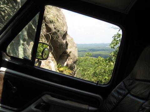 1978 Ford Bronco - The view from the passenger seat shows a large rock formation and a distant valley.