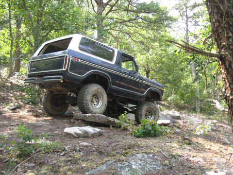 1978 Ford Bronco - This 1978 Ford Bronco navigates a rocky path through a dense forest.