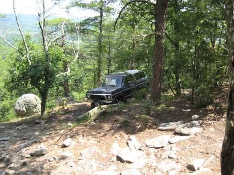 1978 Ford Bronco - A classic 1978 Ford Bronco sits parked on a , wooded trail, overlooking a distant valley.