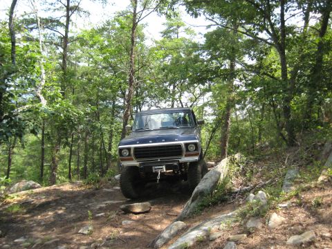 1978 Ford Bronco - This 1978 Ford Bronco navigates a rocky, wooded trail, its off-road capabilities.