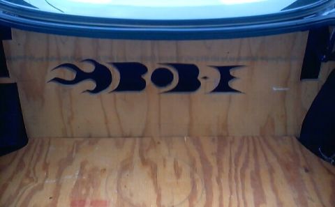1999 Ford Taurus - The trunk interior features custom wood paneling with black flame graphics.