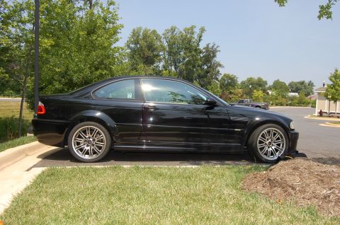 2002 BMW M3 - Side view of a black 2002 BMW M3 coupe parked outdoors on a sunny day.