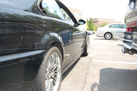 2002 BMW M3 - A black 2002 BMW M3 coupe is parked in a lot, with a pickup truck to its right.