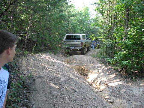 1978 Ford Bronco - A 1978 Ford Bronco navigates a rough dirt trail with another vehicle following behind.