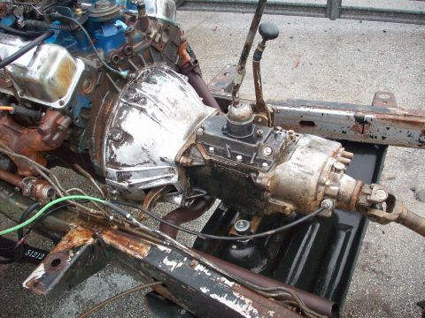 1978 Jeep CJ5 - Close-up view of a vehicle's engine and transmission components, showing rust and wear.