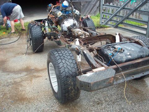 1978 Jeep CJ5 - The chassis of a 1978 Jeep CJ5 is shown with its engine and drivetrain components visible.